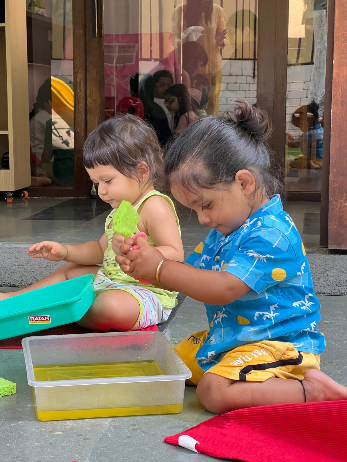 Two toddlers at sensory water play