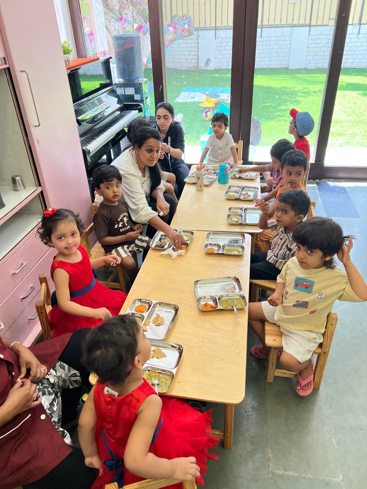 Children eating lunch together at a long table